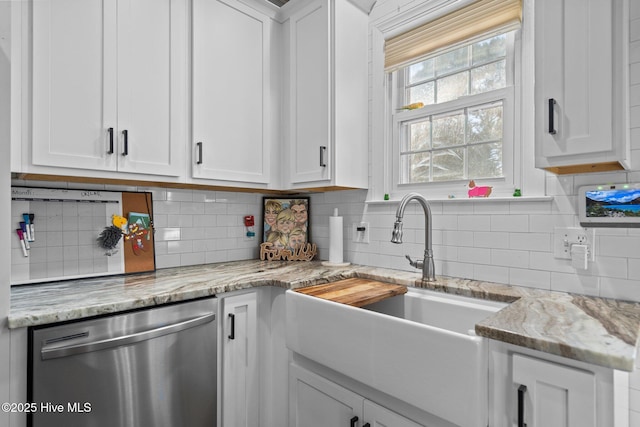 kitchen featuring light stone counters, white cabinets, tasteful backsplash, and dishwasher