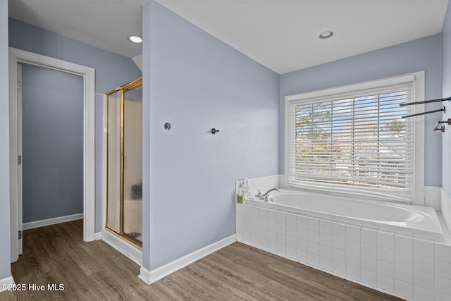 bathroom with wood-type flooring and independent shower and bath