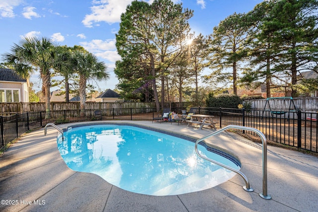 view of swimming pool with a patio area