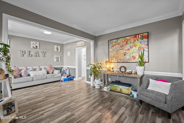 living room with ornamental molding and wood-type flooring