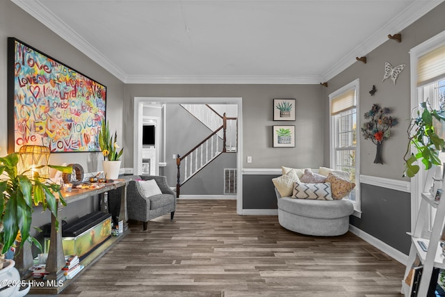 sitting room featuring hardwood / wood-style floors and crown molding