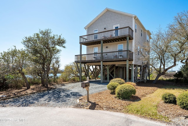 rear view of property featuring a carport and a deck