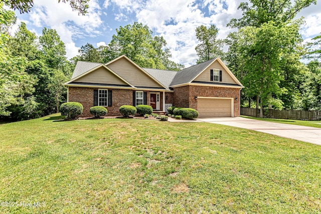 view of front of house with brick siding, fence, a front lawn, and driveway