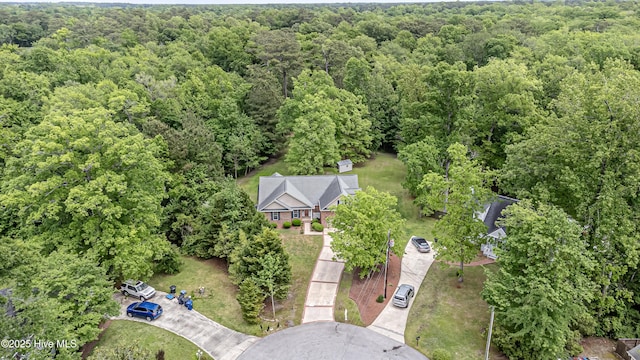 drone / aerial view with a wooded view