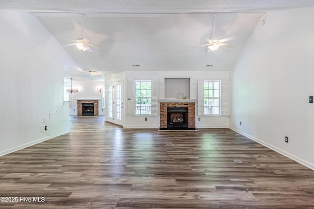 unfurnished living room with high vaulted ceiling, wood finished floors, a ceiling fan, and a fireplace