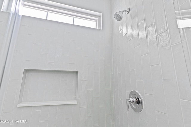 bathroom with tiled shower