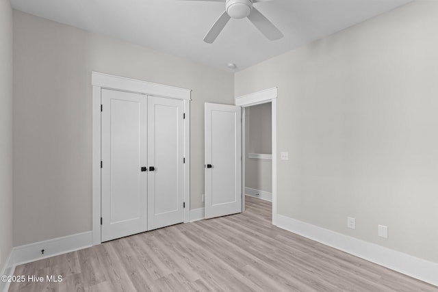 unfurnished bedroom with ceiling fan, light hardwood / wood-style flooring, and a closet