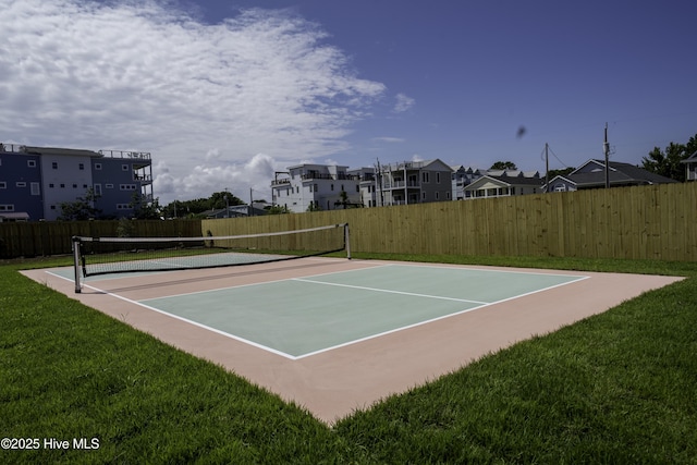 view of sport court featuring a lawn