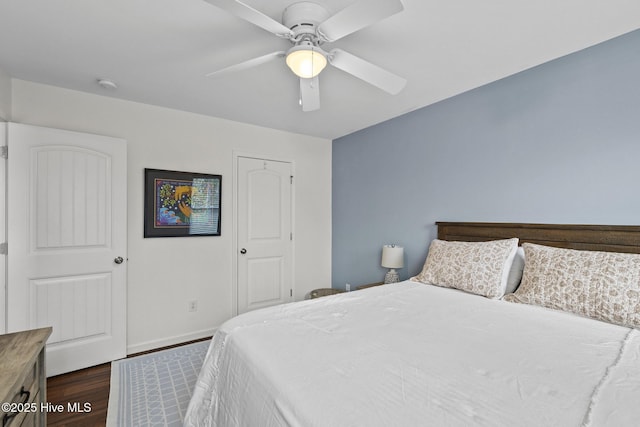 bedroom featuring dark wood-type flooring and ceiling fan