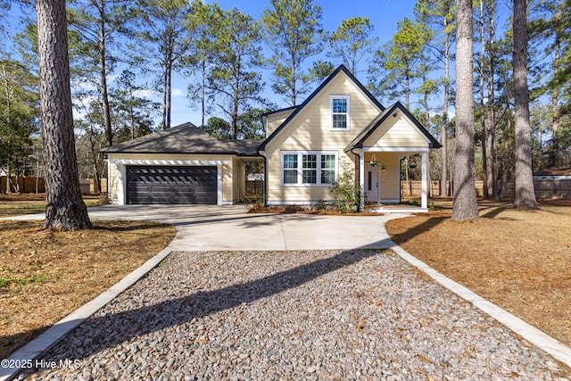 view of front of house with an attached garage, driveway, and a porch