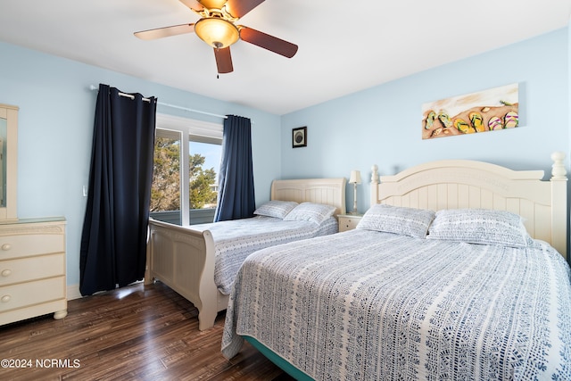 bedroom with a ceiling fan and dark wood finished floors