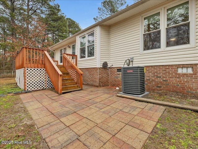 view of patio with central AC unit and a deck