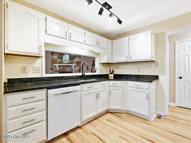 kitchen with light hardwood / wood-style floors, dishwasher, sink, and white cabinets