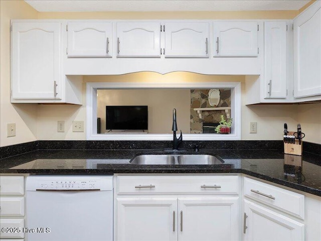 kitchen featuring white dishwasher, sink, and white cabinets