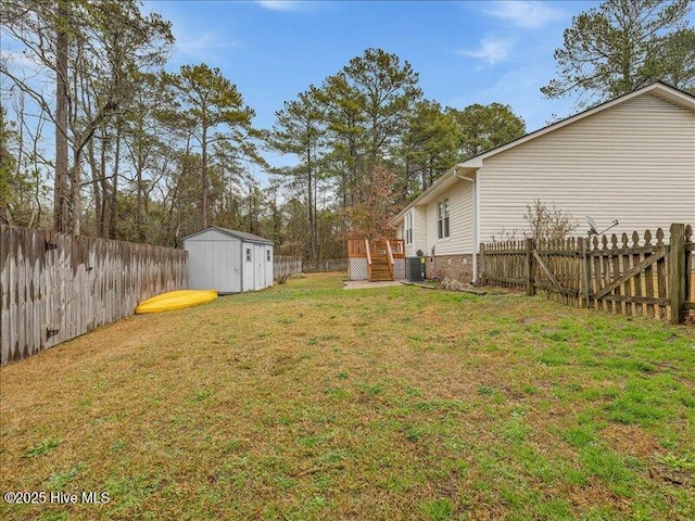 view of yard featuring a deck, central AC unit, and a storage unit