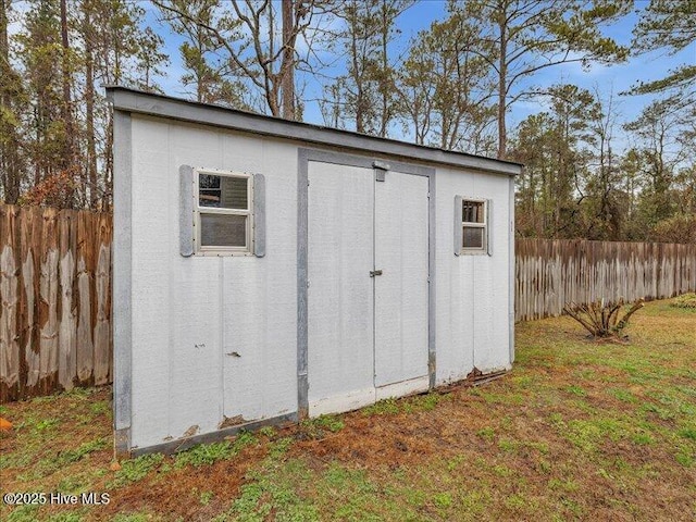 view of outbuilding with a lawn