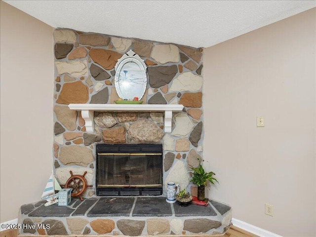 interior details with a fireplace and a textured ceiling