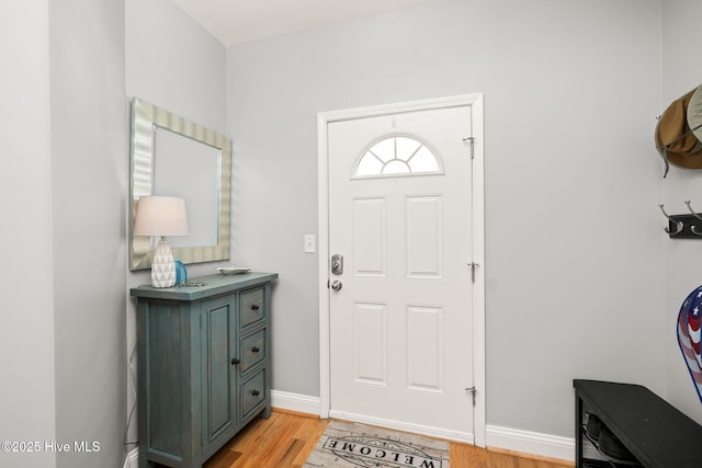 foyer featuring light wood finished floors and baseboards