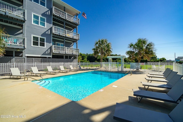 community pool featuring a patio area and fence