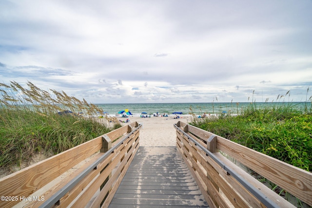 view of community featuring a beach view and a water view