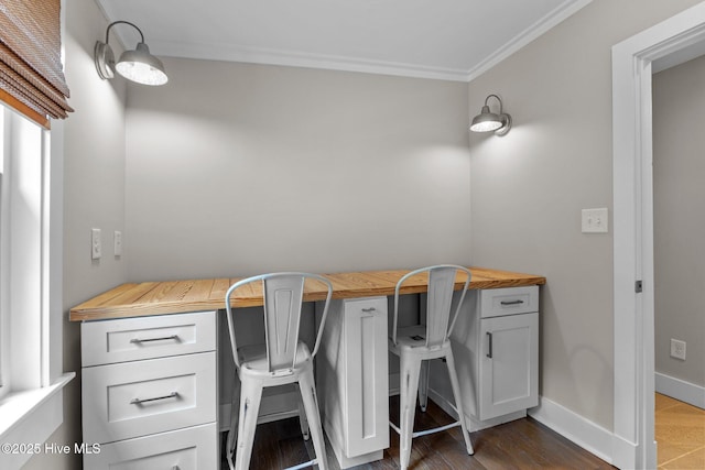 office featuring dark wood-type flooring and ornamental molding