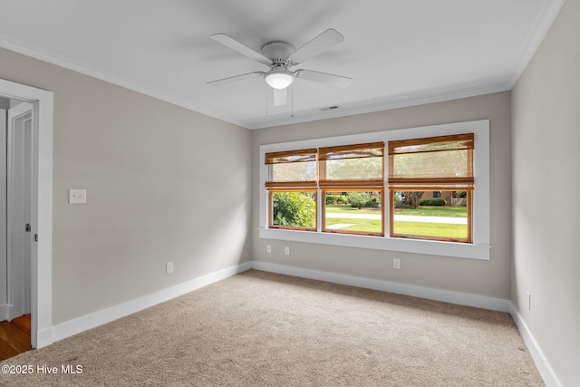 carpeted empty room featuring crown molding and ceiling fan