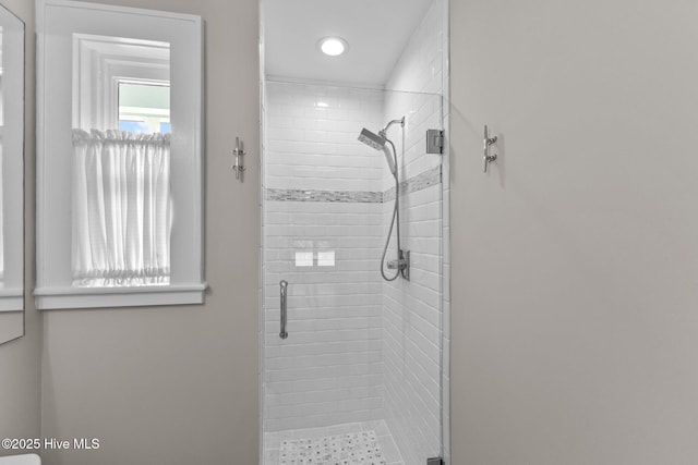 bathroom with a shower with door