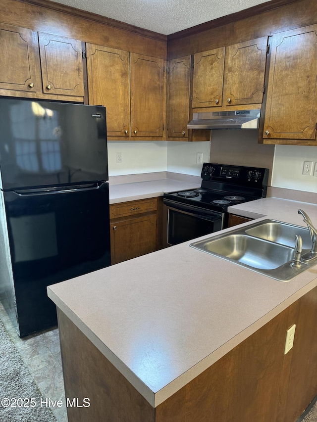 kitchen with sink, black appliances, and a textured ceiling