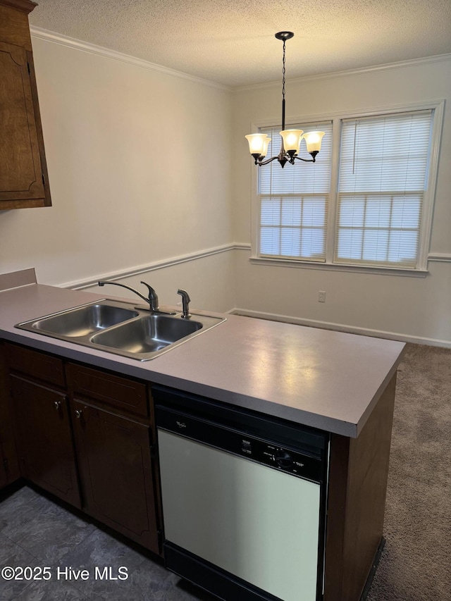 kitchen with pendant lighting, sink, crown molding, dark brown cabinetry, and stainless steel dishwasher