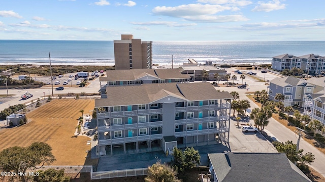 birds eye view of property with a water view and a beach view