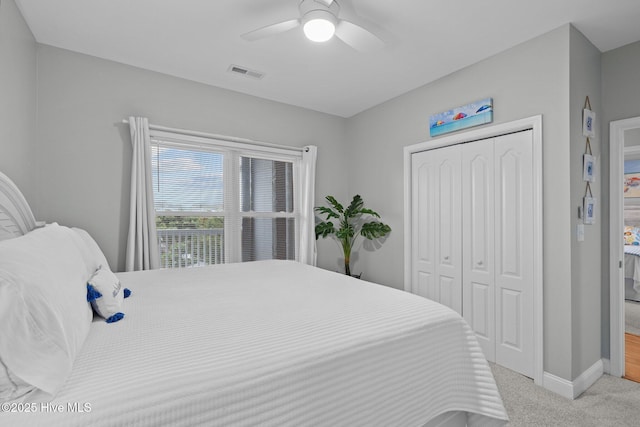 carpeted bedroom with a closet and ceiling fan