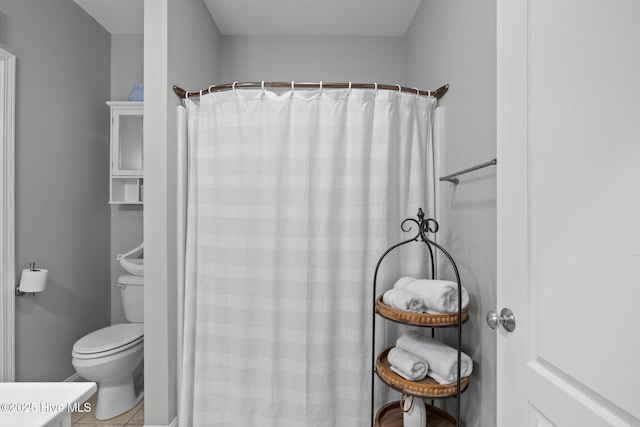 bathroom with toilet and curtained shower