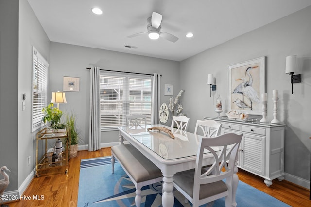 dining room with light wood-type flooring and ceiling fan