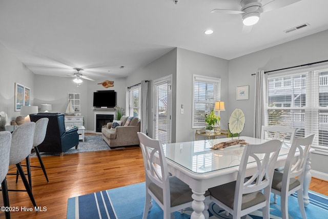 dining space featuring ceiling fan and light wood-type flooring