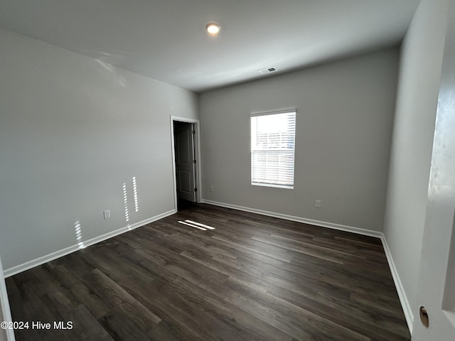 spare room featuring dark hardwood / wood-style floors