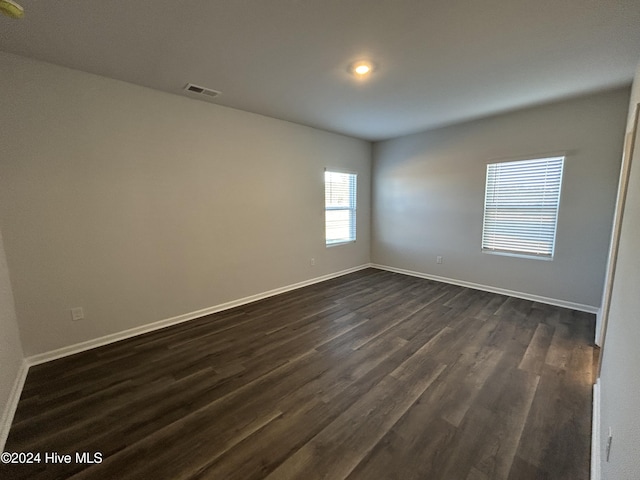 empty room with dark hardwood / wood-style floors