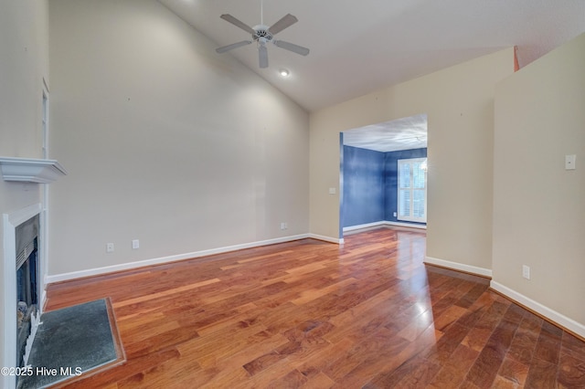 unfurnished living room with hardwood / wood-style flooring, high vaulted ceiling, and ceiling fan