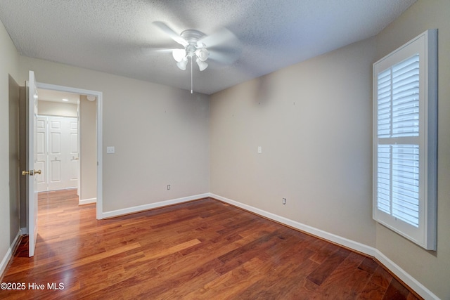 unfurnished room with hardwood / wood-style flooring, ceiling fan, and a textured ceiling