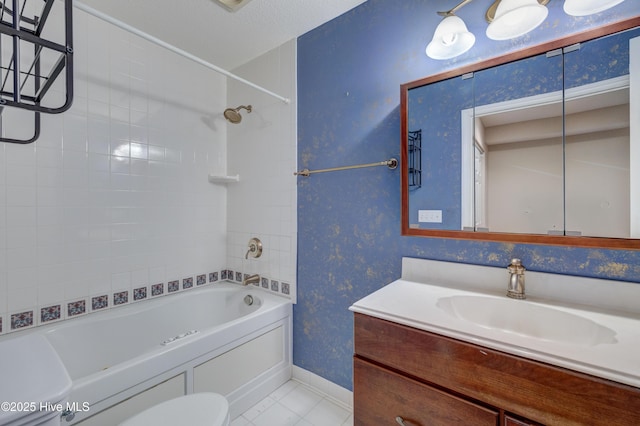 full bathroom featuring vanity, toilet, tiled shower / bath combo, and tile patterned flooring