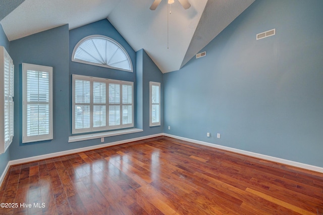 unfurnished room with ceiling fan, high vaulted ceiling, hardwood / wood-style floors, and a wealth of natural light