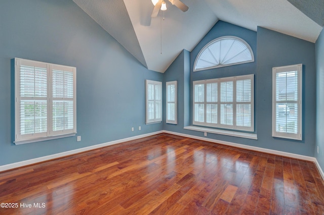 spare room with ceiling fan, high vaulted ceiling, and hardwood / wood-style floors