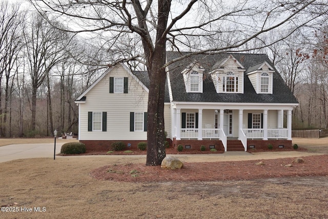 cape cod-style house with covered porch