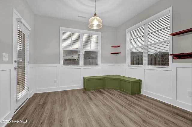 unfurnished dining area featuring plenty of natural light and light hardwood / wood-style floors