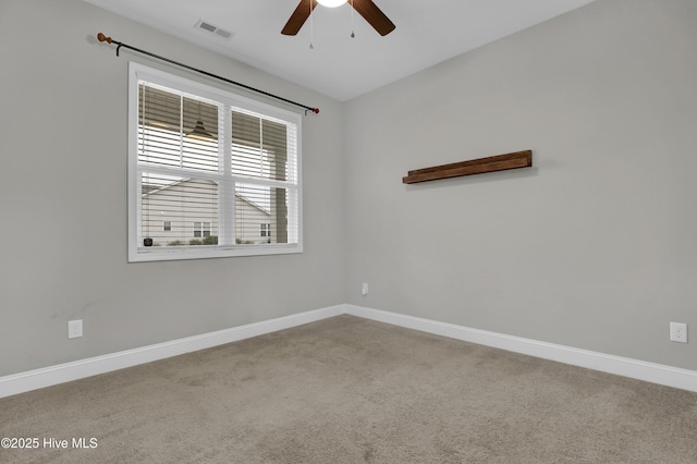 carpeted spare room featuring ceiling fan