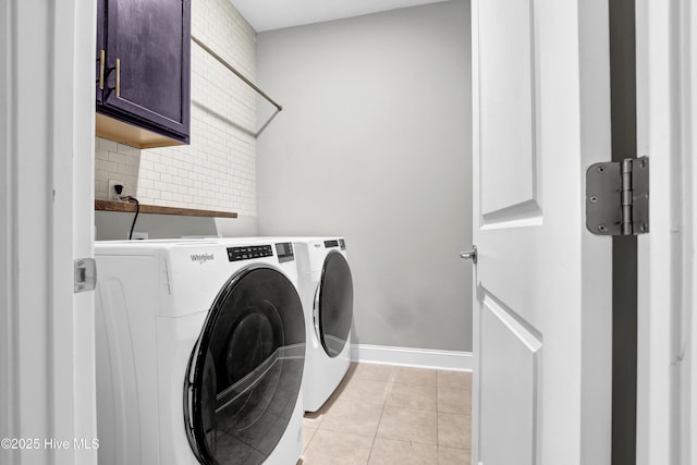 washroom with cabinets, light tile patterned flooring, and separate washer and dryer