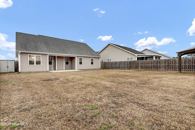 rear view of property featuring a patio and a lawn