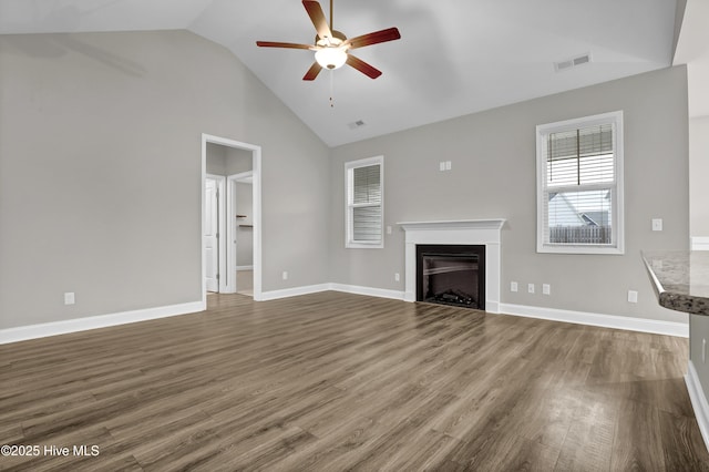 unfurnished living room with hardwood / wood-style floors, high vaulted ceiling, and ceiling fan