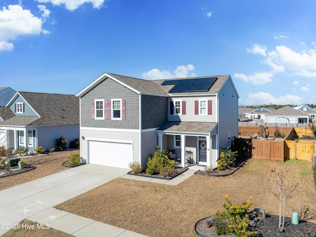 view of front facade featuring a front lawn, solar panels, and a garage