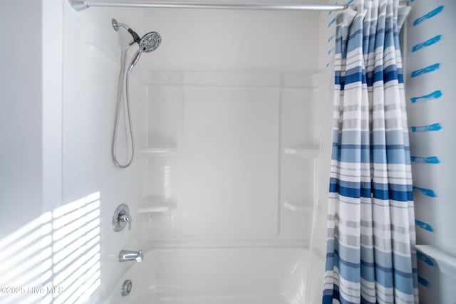 bathroom with shower / bath combination with curtain