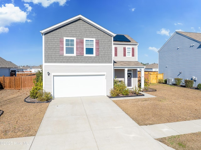 view of property featuring a garage, solar panels, cooling unit, and a front yard